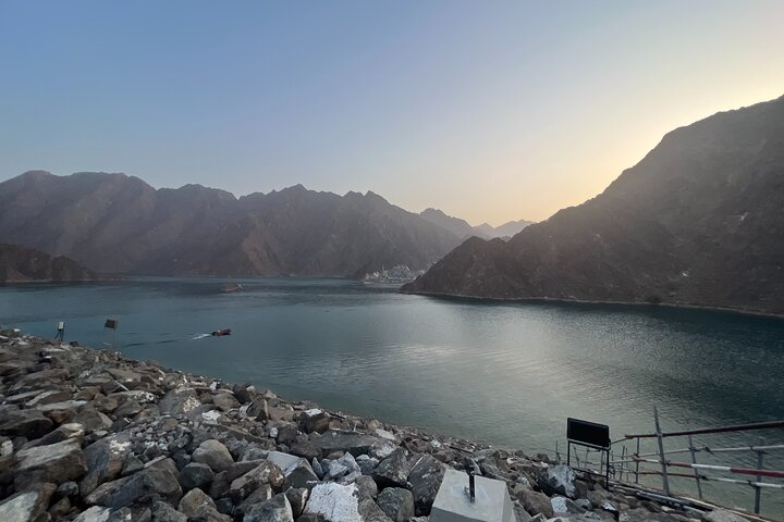 Explore Hatta's stunning landscape where majestic mountains embrace a serene lake creating an ideal setting for hiking kayaking and unforgettable outdoor adventures amidst nature's beauty.